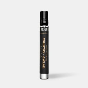 Black travel size perfume atomiser with a black cap and label, standing upright on a plain light grey background.