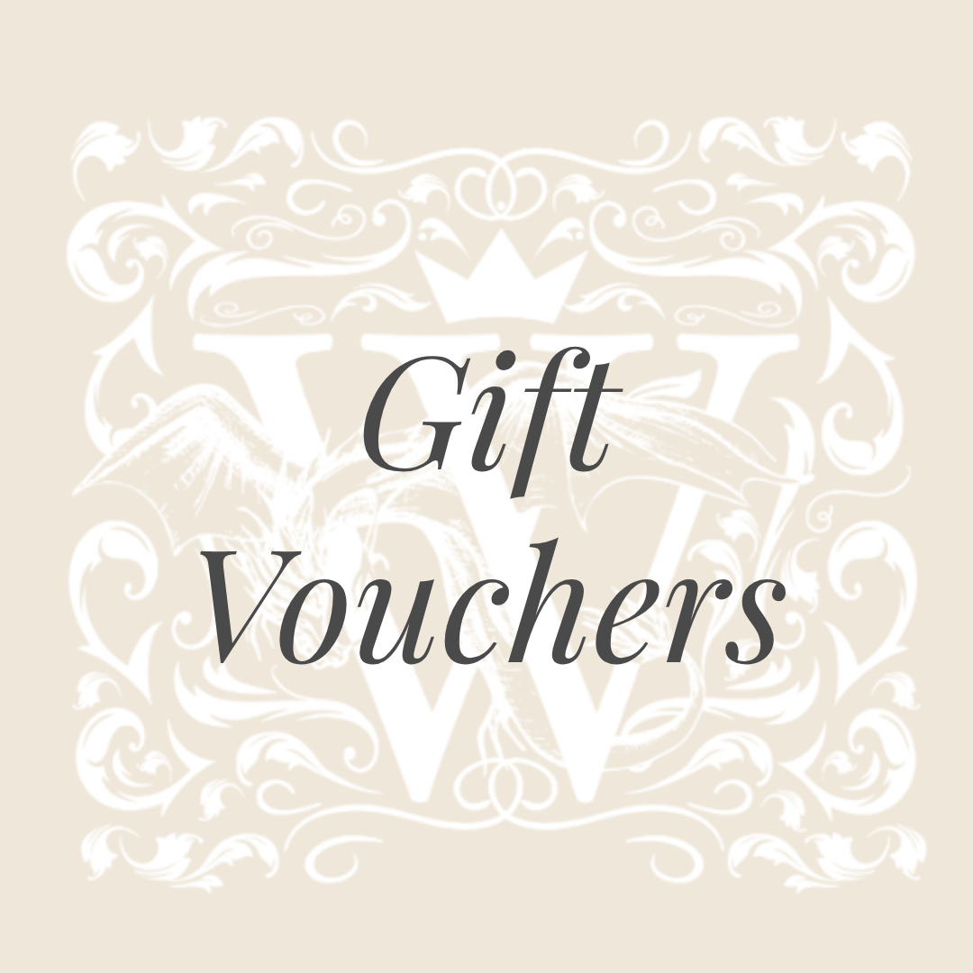The words "Gift Vouchers" in white italic lettering on a soft beige background, over a faint Wales Perfumery crest.