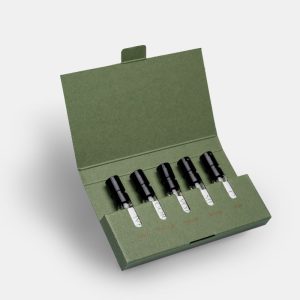 a set of five sample size 2ml perfume bottles in a green presentation box
