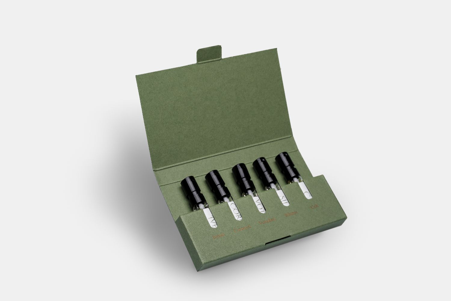 a set of five sample size 2ml perfume bottles in a green presentation box