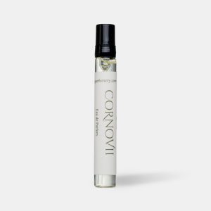 a modern slim perfume bottle with an off white label with green text. The perfume is called Cornovii by Wales Perfumery