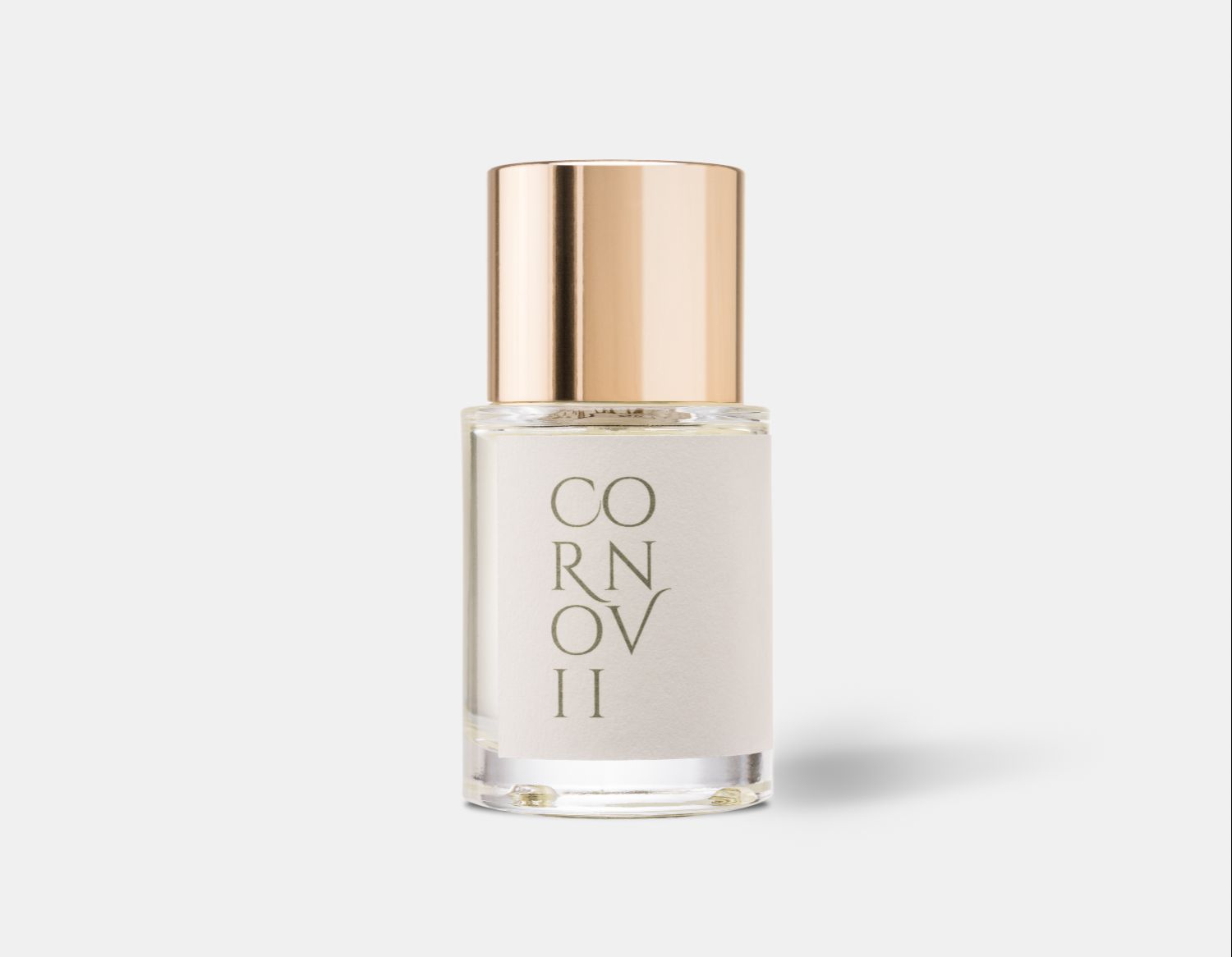 a modern perfume bottle with a shiny gold cap and off white label with green text. The perfume is called Cornovii by Wales Perfumery
