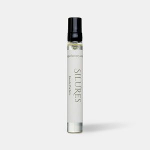 Travel size perfume atomiser with a black cap and cream label, standing upright on a plain light grey background.