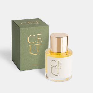 a bottle of parfum, the bottle has a cream label saying celt, and a glossy gold cap. it is next to a green box also saying celt in gold print