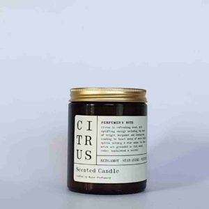 an amber glass jar with a gold screw cap lid, and a cream paper label. the label says that this is a scented soy wax candle in citrus scent made by Wales Perfumery