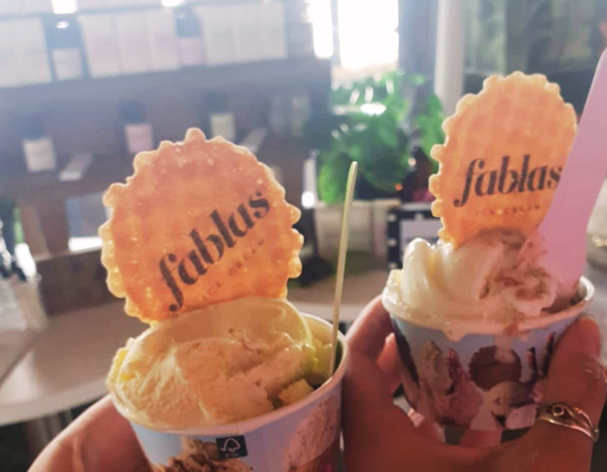 A cup of Fablas ice cream held up at the Wales Perfumery Storii fragrance wardrobe launch party at Fablas Ice Cream Parlour, Barry Island