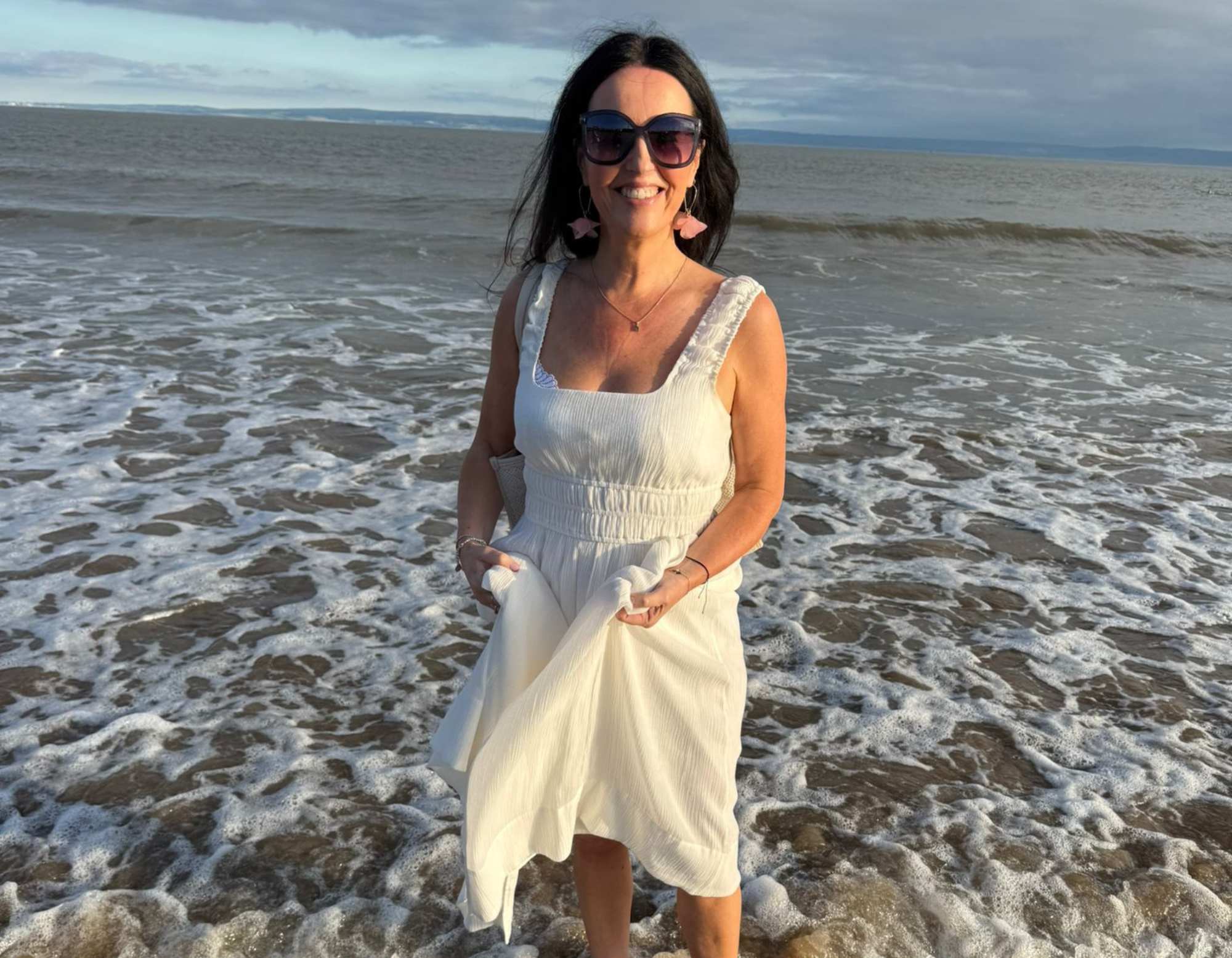 Louise Smith, founder and perfumer of Wales Perfumery, paddling in the sea at Barry Island after the Storii collection launch event