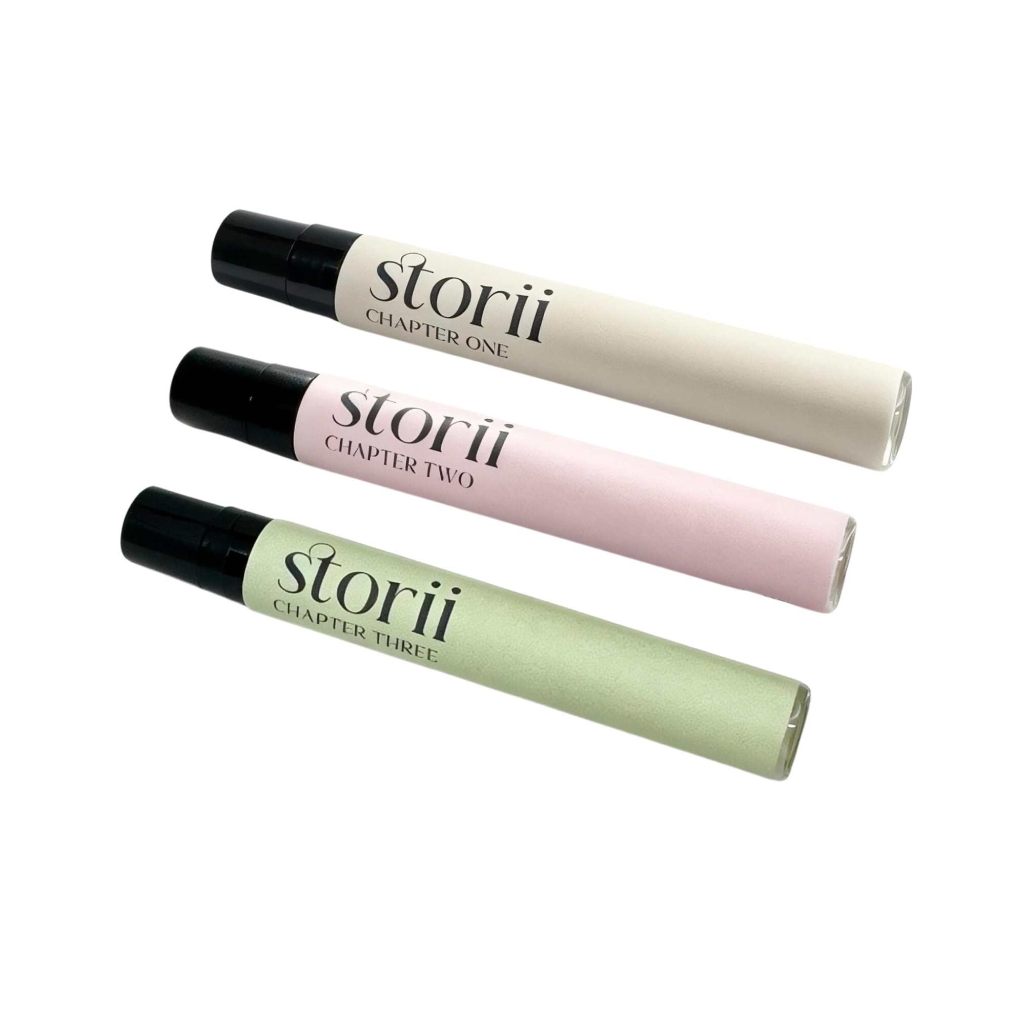 Three Storii 7ml perfume sprays, Chapter One, Chapter Two and Chapter Three, arranged diagonally on a white background