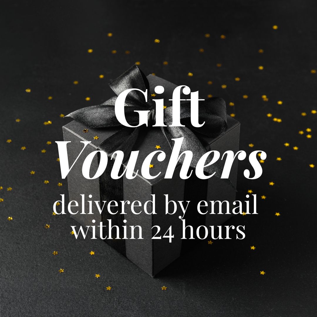 The words “Gift Vouchers, delivered by email within 24 hours” in white lettering over a black gift box tied with a black satin bow, on a dark background scattered with gold stars.