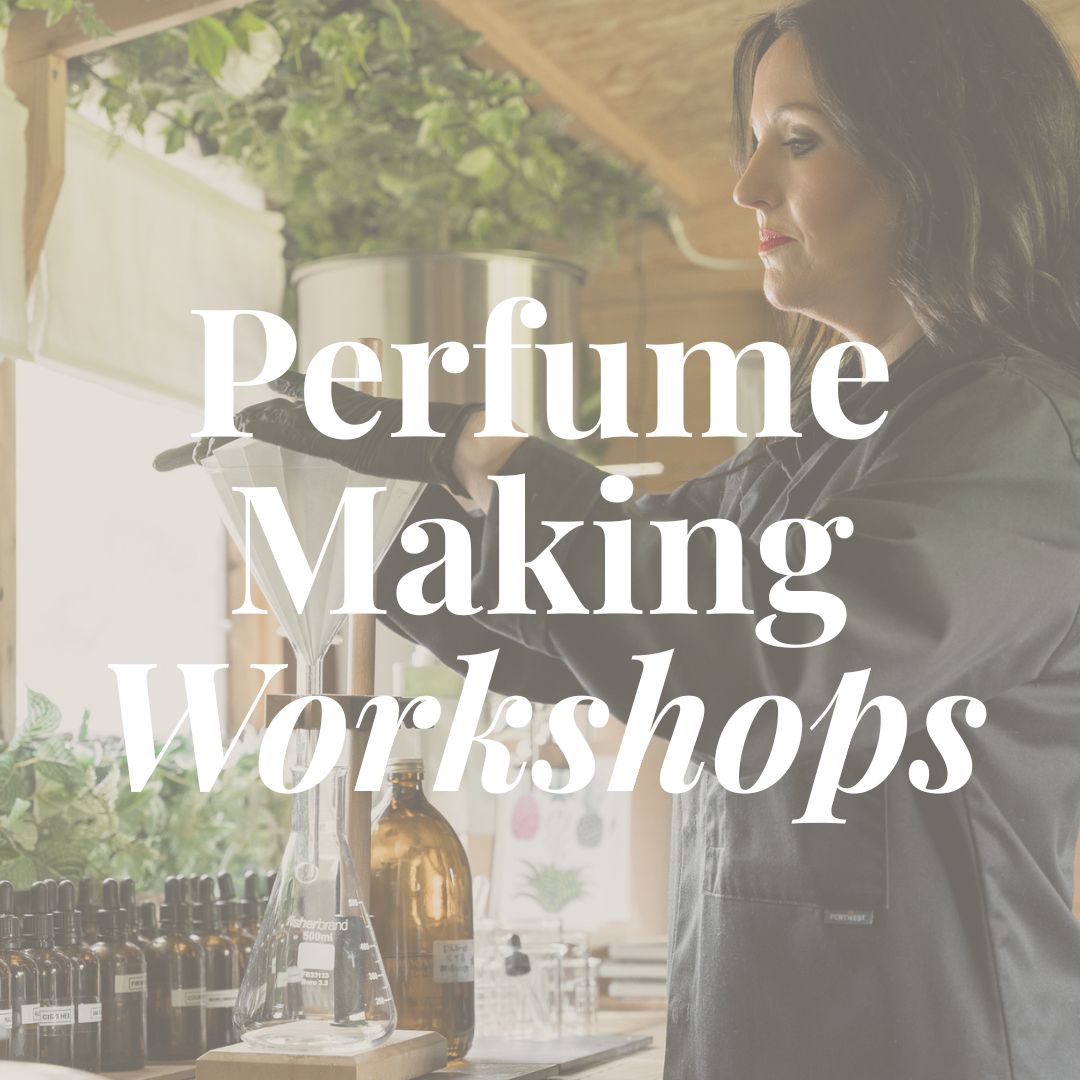 The words “Perfume Making Workshops” in white lettering over perfumer, Louise Smith, in black workwear pouring through a glass funnel into a flask, with amber bottles of perfumery materials on the bench.