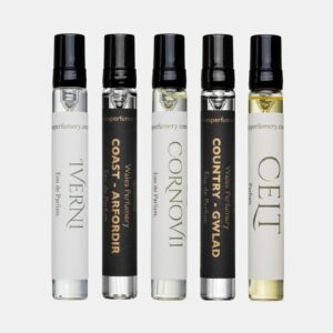 Five Wales Perfumery sample vials with black spray caps on a light grey background: Coast – Arfordir and Country – Gwlad in black-and-gold labels with a white-labelled Cornovii & Iverni Eau de Parfum and Celt Parfum
