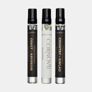 Three Wales Perfumery sample vials with black spray caps on a light grey background: Coast – Arfordir and Country – Gwlad in black-and-gold labels flank a white-labelled Cornovii Eau de Parfum.